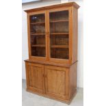 An Edwardian pine kitchen cupboard, glazed upper section with three adjustable shelves,