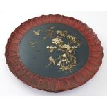 A Japanese Meiji period Hiro Maki-e black lacquer charger with bird and foliate decoration in