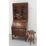 An early-to-mid 20th century oak bureau with associated elevated bookcase and a small late 1930s