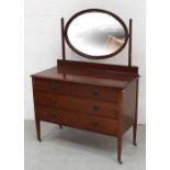 An Edwardian red walnut two-over-two drawer dressing chest with oval mirror and square tapering