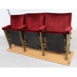 A cast iron framed vintage triple cinema seat finished in burgundy velour, width 160cm.