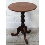 A late 19th century oak tilt-top table on turned support to tripartite base, diameter approx 58cm.