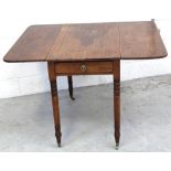 A Victorian mahogany Pembroke table on turned tapering legs to brass castors, when extended 71.