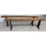 A pair of 19th century trestle benches of peg tenon construction,