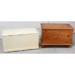 A contemporary pine blanket box with inset front panel on castors and a vintage white-painted