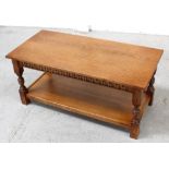 A modern prairie-style oak coffee table with egg and dart frieze over turned legs and shelf