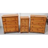 A near pair of modern pine four-drawer chests on bun feet,