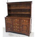 A George III oak North Wales dresser, the plate rack with later cornice,