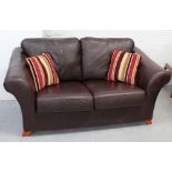 A contemporary chocolate brown leather two-seat sofa and a matching leather pouffe (2).