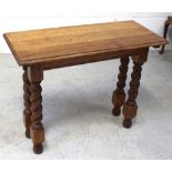 An early-to-mid 20th century oak hall table on wrythen supports and ball feet, length 90cm.