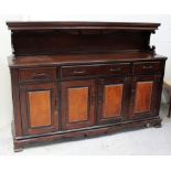 A reproduction 17th century Spanish-style sideboard with shaped carved backrail above one long