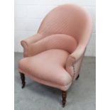 A Victorian-style tub chair, curved back to scrolling arms on front turned supports and castors.