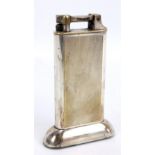 DUNHILL; an electroplated table lighter with engine turned decoration, height 10cm.