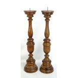 A pair of modern beech pricket style candlesticks, height 60cm.