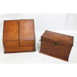 A Victorian oak stationery box with hinged top and two fold fall-front with numerous compartments,