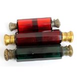 Two Victorian green and ruby faceted glass double scent bottles, one with gilt metal hinged caps,