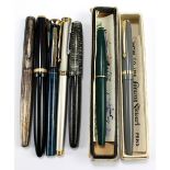 A group of fountain pens comprising Parker Maxima, Parker Vacumatic,