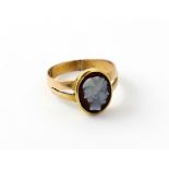 An 18ct gold cameo glass ring with white bust of winged Mercury to a black ground, size I 1/2,