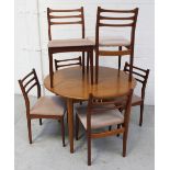 A retro circular extending dining table and six matching dining chairs,