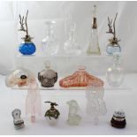 A collection of perfume bottles to include Art Deco style pink perfume bottle with stopper modelled