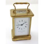 Matthew Norman; a 20th century brass carriage clock, the white dial set with Roman numerals,