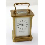 Matthew Norman; a 20th century brass carriage clock, the white dial set with Roman numerals,