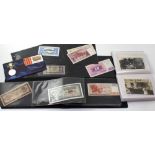 An album of various world banknotes and a 20th century postcard album (2).