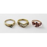 Three yellow metal ladies' dress rings; one set with small peridot,