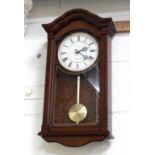 A contemporary mahogany-cased wall clock of small proportions, white dial set with Roman numerals,