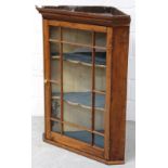 A 19th century oak wall-hanging corner cabinet, single glazed drawer, three interior shelves,