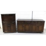 An Ercol dark oak sideboard, four frieze drawers over four cupboard doors, on plinth base,