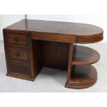 A mahogany kneehole desk with rounded top, three drawers and shelves, width 140cm.