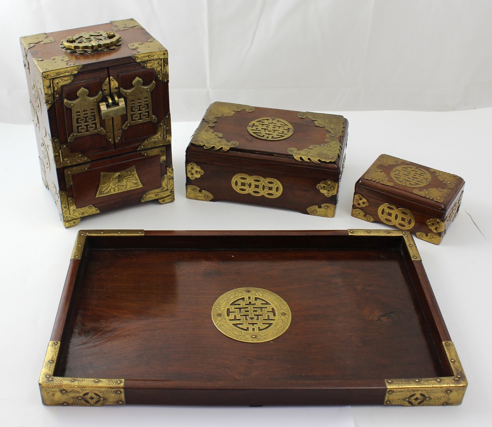 A collection of brass-mounted Oriental hardwood boxes to include a chadansu cabinet and a tray (4).