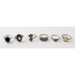 A set of six silver dress rings including a black onyx example, a hematite solitaire,