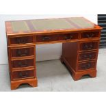 A reproduction yew wood desk, width 121.5cm.