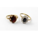 A 9ct gold garnet dress ring, size N, and a 9ct gold sapphire cluster ring, size O,