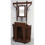 An Arts and Crafts style walnut hall stand with mirror back above marble top and single drawer,