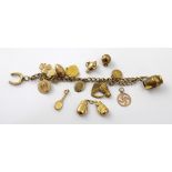 A 9ct gold charm bracelet with charms to include boxing gloves, football, rugby ball,