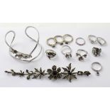 Nine various silver rings to include floral examples, blue topaz etc,