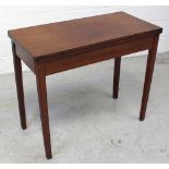 A late 19th/early 20th century mahogany fold-over card table on tapering supports,