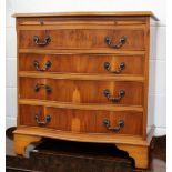 A reproduction yew wood serpentine-front chest of four long drawers, width 73cm.