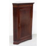 A 19th century mahogany inlaid corner unit, Greek key frieze above single door,