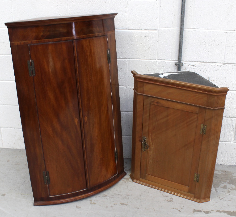 A George III mahogany bow-front corner cabinet with white painted interior, height 112.