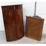 A George III mahogany bow-front corner cabinet with white painted interior, height 112.