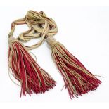 An officer's red and gold bullion sash/belt with knots and tassels to ends,