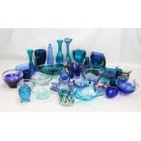 A large collection of blue tinted glass including vases, bowls, shaped dishes, ashtrays, etc.