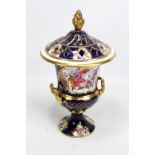 A 19th century porcelain campana potpourri painted with panels of floral sprays on gilt heightened