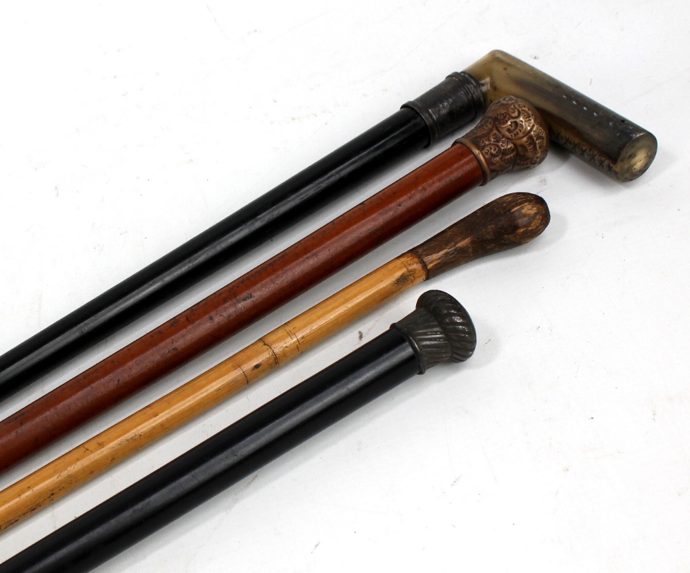 Four various walking sticks to include a horn handled and silver collared ebonised example,