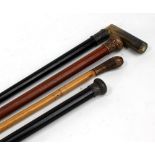 Four various walking sticks to include a horn handled and silver collared ebonised example,