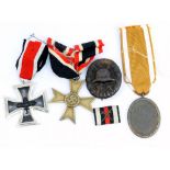 A Third Reich West Wall Medal with envelope of issue, a 1939 War Merit Cross,